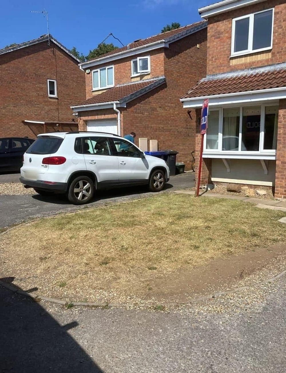 The same front lawn cut and cleared
